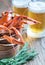 Bowl of boiled crayfish with two mugs of beer