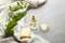 Bowl, bottle of eucalyptus essential oil and soap on light background