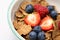 Bowl of breakfast cereal with fruit.