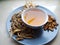 Bowl of brewed chinese herbs with dried assorted roots aside.