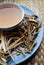 Bowl of brewed chinese herbs with dried assorted roots aside.