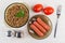 Bowl with buckwheat, salt, pepper, tomatoes, saucer with sausage