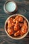 Bowl of buffalo wings with blue cheese dip