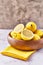 Bowl of bunch of lemons and halves on a marble surface