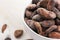 Bowl of cacao beans on a white background