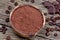 Bowl with cacao powder and coffee beans on rustic table