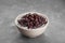 Bowl of canned kidney beans on grey table