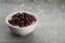 Bowl of canned kidney beans on grey table. Space for text