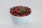 Bowl of canned kidney beans with parsley on white wooden table, closeup