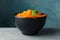 Bowl with carrot salad on gray table Korean food