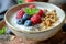 a bowl of cereal, granola, berries and chia seeds