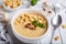 Bowl of champignon mushroom cream soup puree with croutons and basil leaf