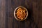 Bowl of Chana Masala Chickpeas on dark wooden surface.