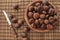 Bowl of chestnuts on bamboo placemat. Focus on bowl.