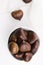 Bowl of chestnuts on a white background