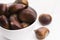 Bowl of chestnuts on a white background