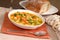 Bowl of chicken noodle soup with rustic bread