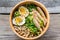 Bowl of chicken ramen soup on the wooden table