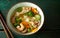 Bowl of Chinese wonton soup with dumplings