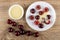 Bowl with condensed milk, cherries with condensed milk in saucer, cherry on table. Top view