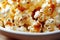Bowl with cooked caramel popcorn of attractive golden brown color.