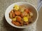 Bowl of cooked carrots and onions and squash on counter