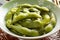 Bowl with cooked edamame beans with salt for a snack close up