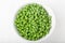 A bowl of cooked green peas, top view