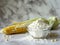 bowl with corn starch on kitchen table and ear of corn