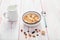 Bowl of cornflakes and milk, hazelnut, dry apricot, walnut and n