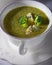 A bowl of creamy broccoli soup with blue cheese.