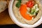 A bowl of creamy hummus with fresh vegetables