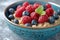 A bowl of creamy oatmeal adorned with fresh berries and a swirl of honey.