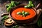 A bowl of creamy tomato soup with a garnish of fresh basil leaves