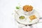 A bowl with crispy cheese crackers on white background