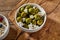 Bowl of cured green olives with muesli for breakfast