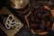 A bowl of dates with rosary and holy quran over the wooden background.