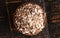 Bowl of Dehydrated Dandelion Root on a Rustic Wooden Table