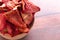 Bowl of Dehydrated Strawberry Halves on a Wooden Countertop