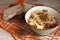 A bowl of delcious homemade stew with potato, turnip, sausages, celery, and onion. Served with fresh bread. European kitchen