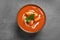 Bowl of delicious butter chicken on grey, top view. Traditional indian Murgh Makhani