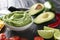 Bowl with delicious guacamole, lime and vegetables on slate plate