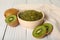 Bowl of delicious kiwi jam and fresh fruits on white wooden table