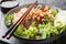 Bowl of delicious mixed beef noodle salad Pho Tron closeup. Horizontal