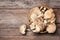Bowl of delicious organic oyster mushrooms on wooden background, top view