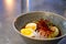 Bowl of delicious ramen with egg and various garnishings