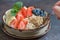 Bowl of delicious steel cut oats with fresh fruit, honey