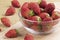 Bowl of delicious strawberries on a wooden background