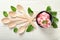 Bowl with delicious strawberry ice-cream and spoons on white wooden background