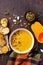 Bowl with diet autumn pumpkin cream soup served with seeds and crouton on stone table top view